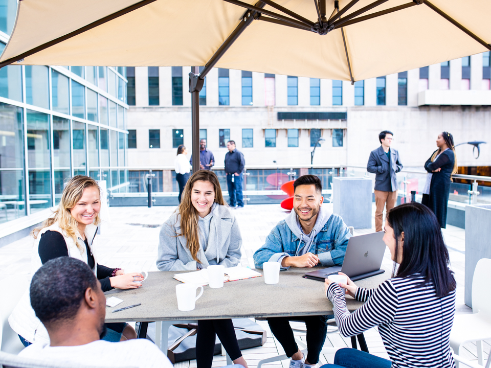 Cisco Meraki team members gather on a rooftop deck