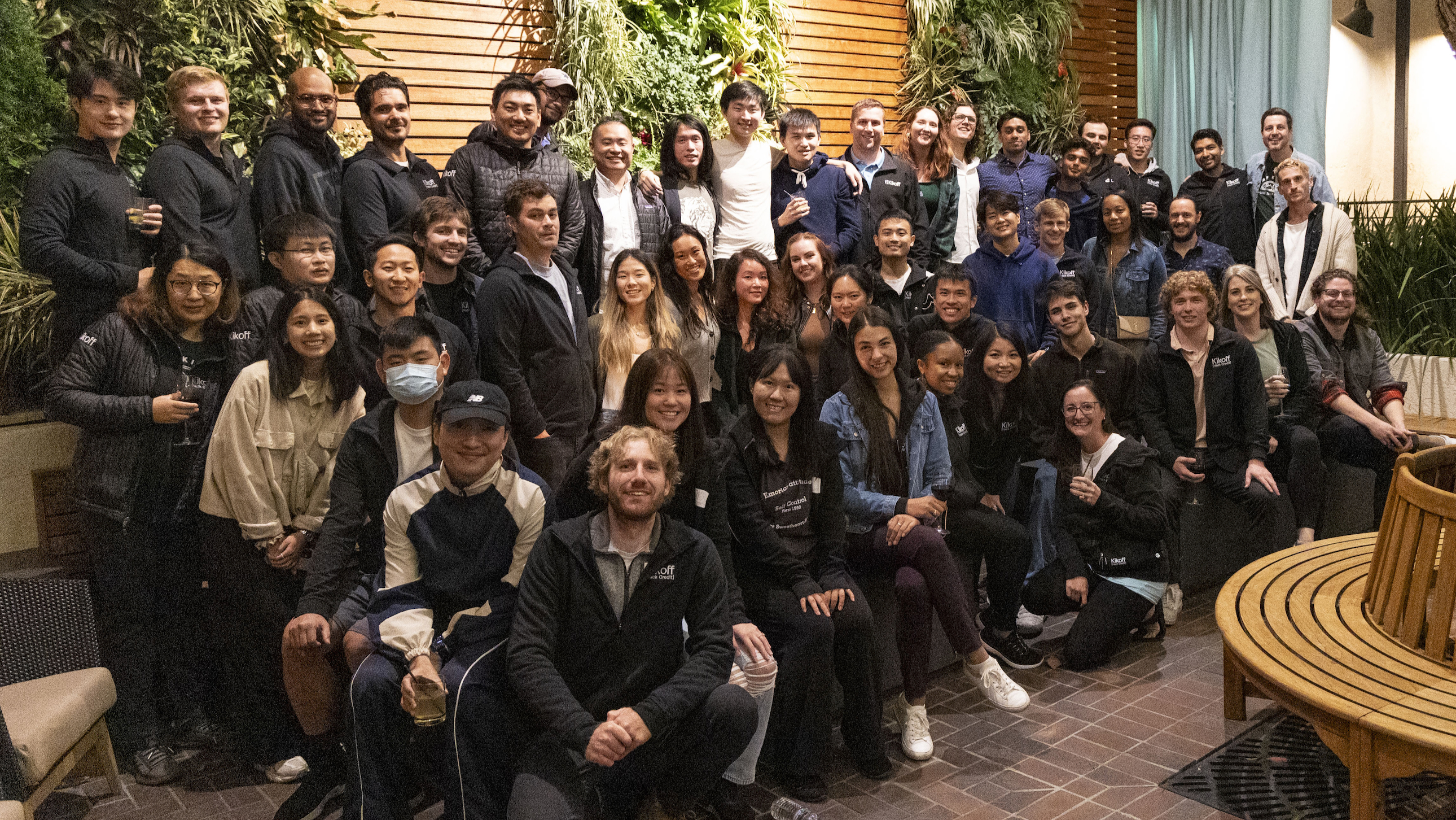 Large group photo of Kikoff team in courtyard setting.