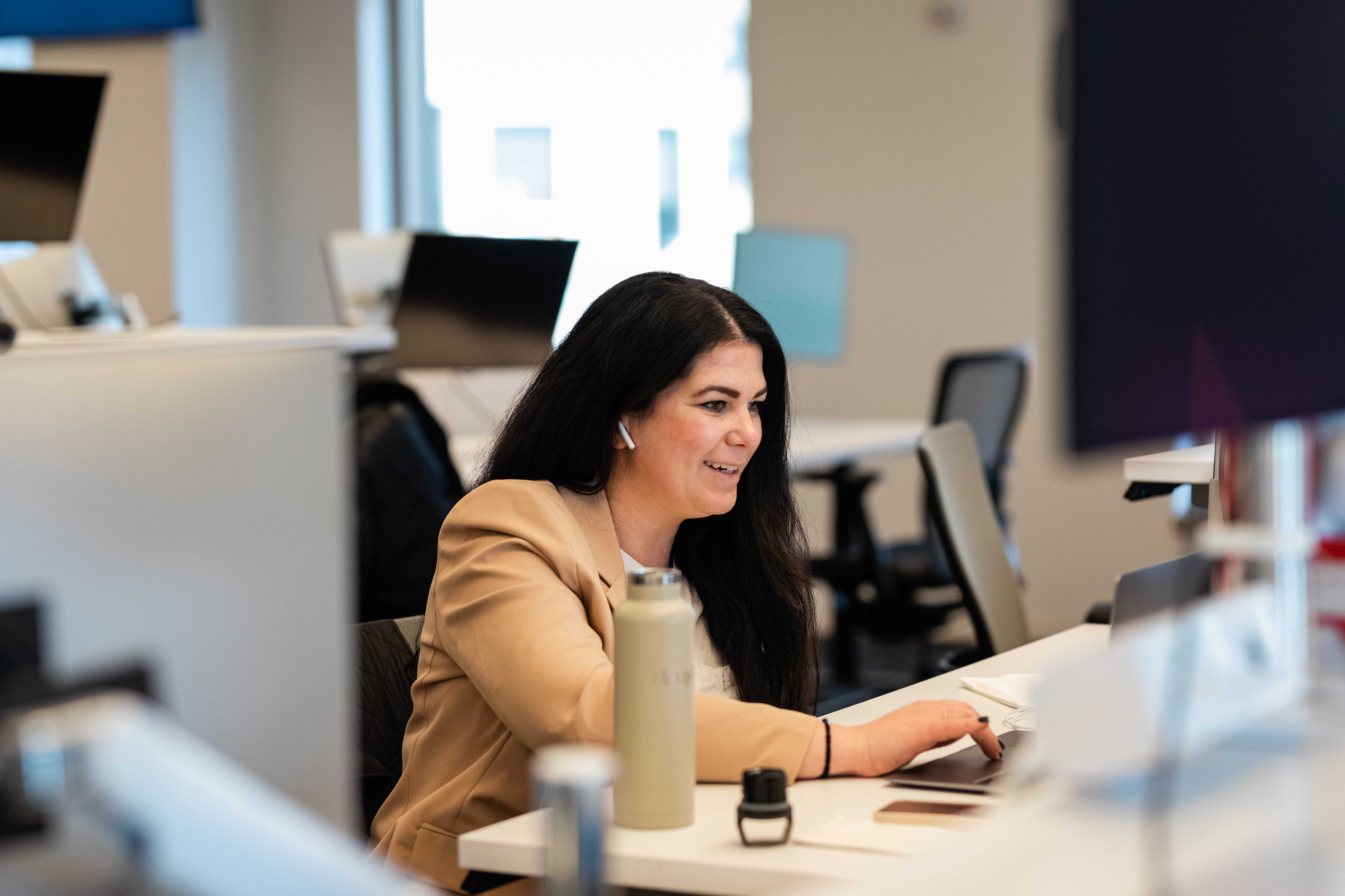 A team member works at their desk during a hackathon.