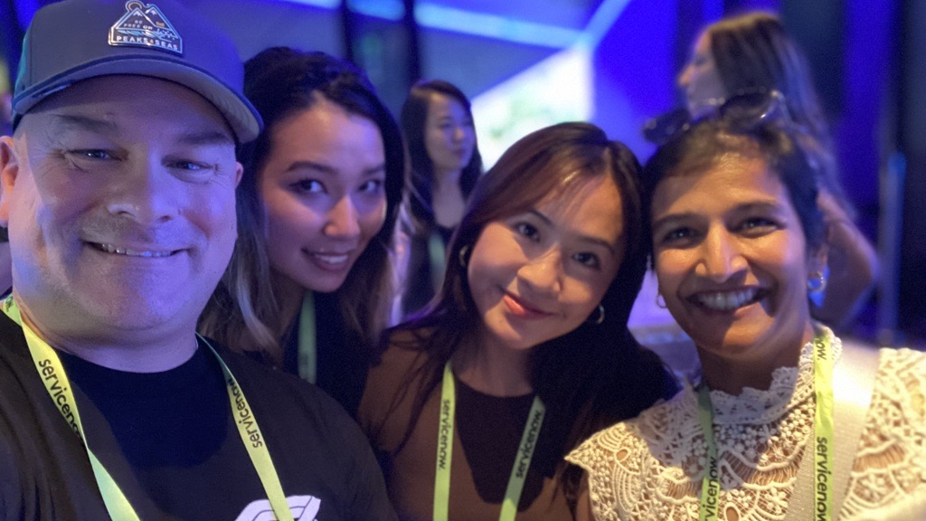 Four ServiceNow team members pose for a selfie at one of the company’s UTG Connect events.