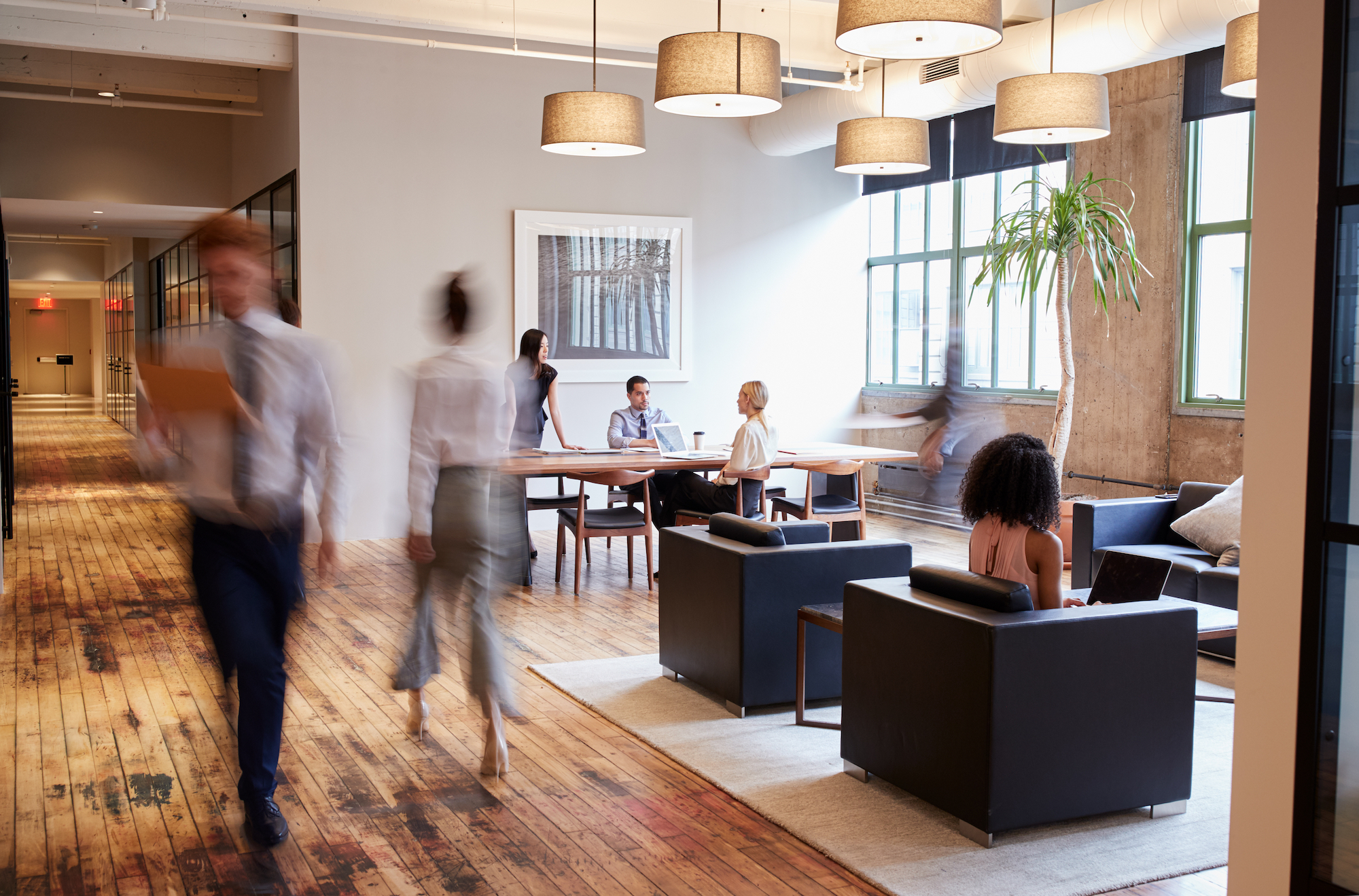 A photo of employees in an office is shown.