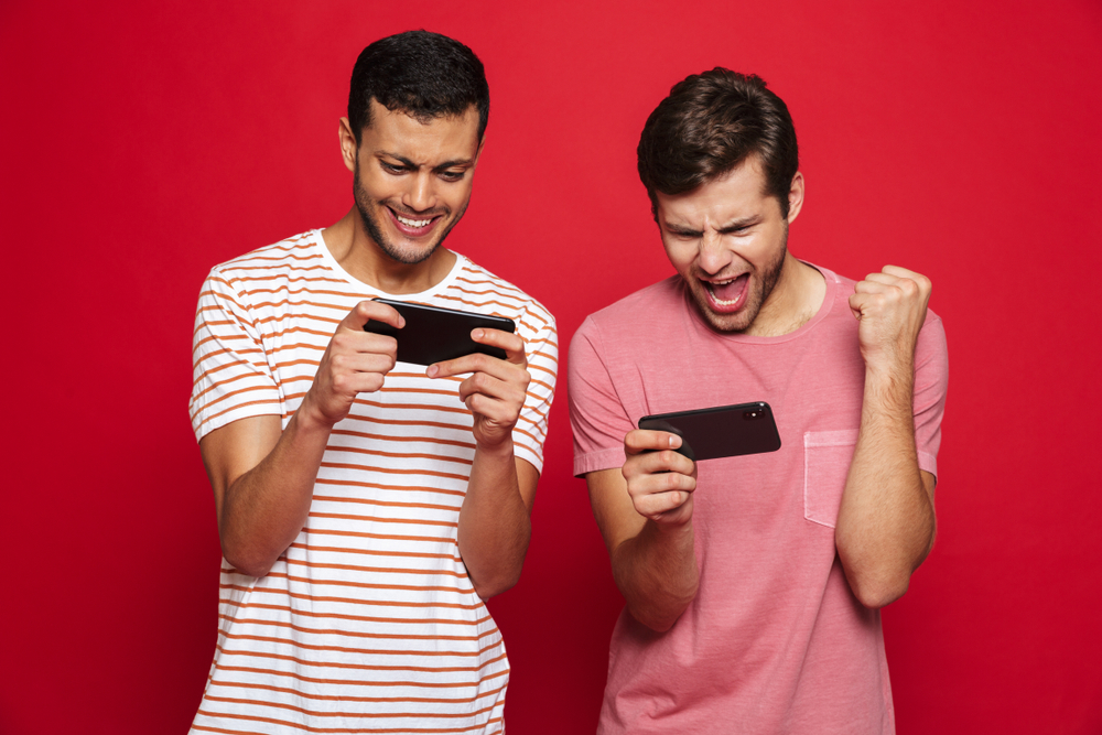 Two users play games using their mobile phones.
