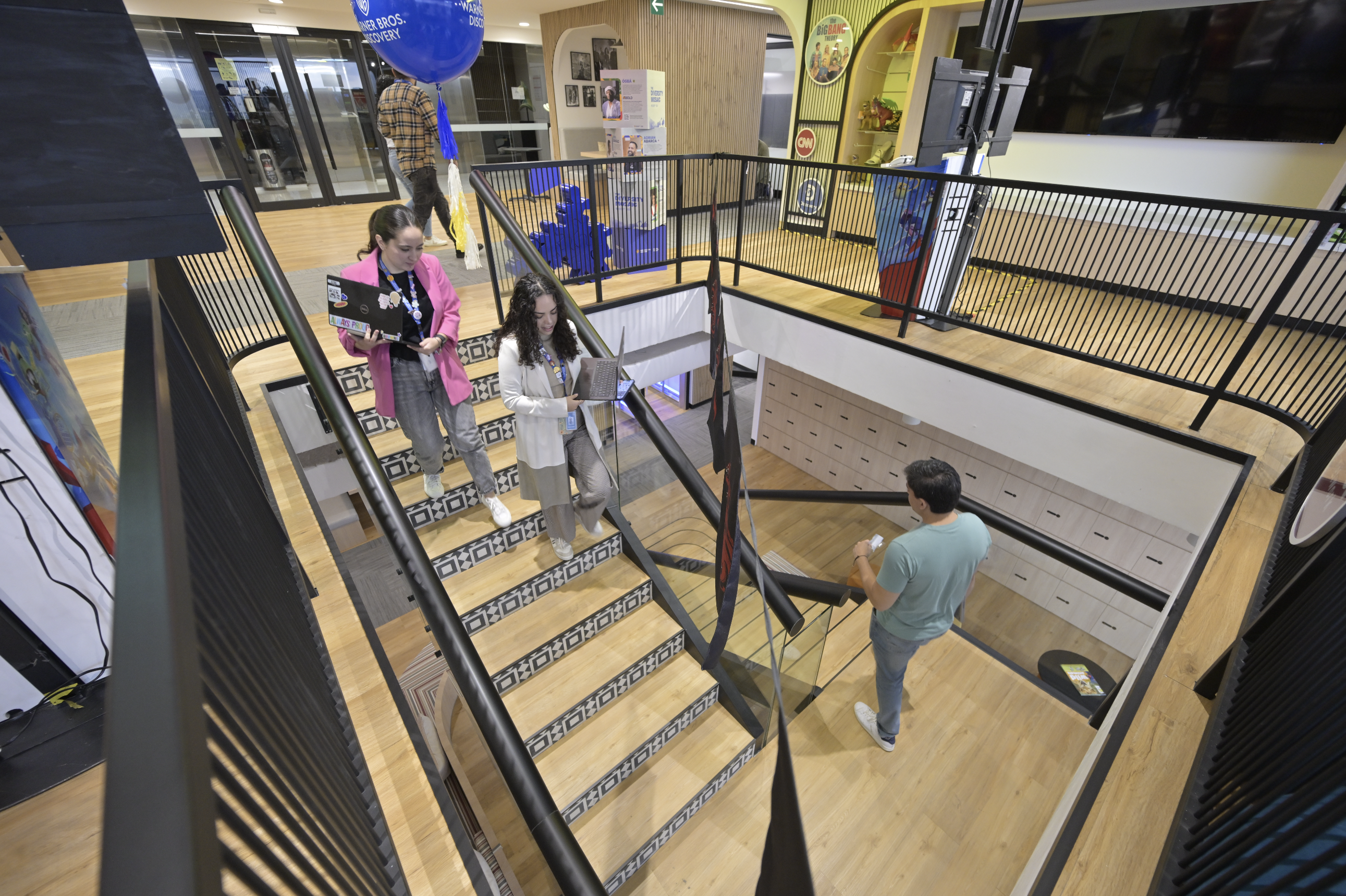 An overhead image of a stairwell in the WBD offices with employees descending the stairs.